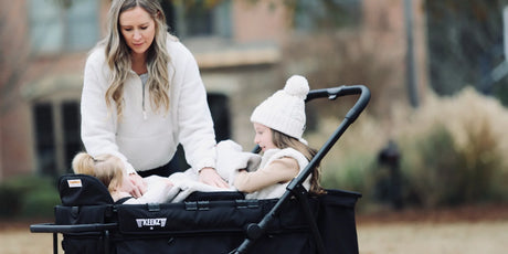 Parent checking a stroller wagon wheel before a family outing